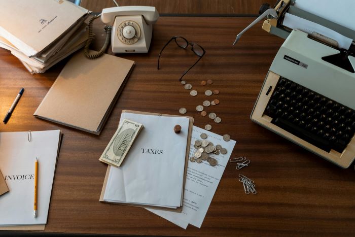 A messy desk with stuff scattered everywhere